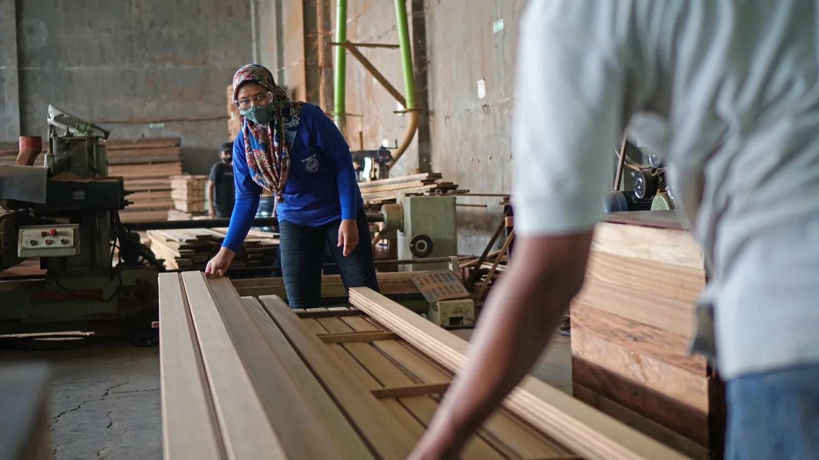 A workshop team inspecting wooden components during production